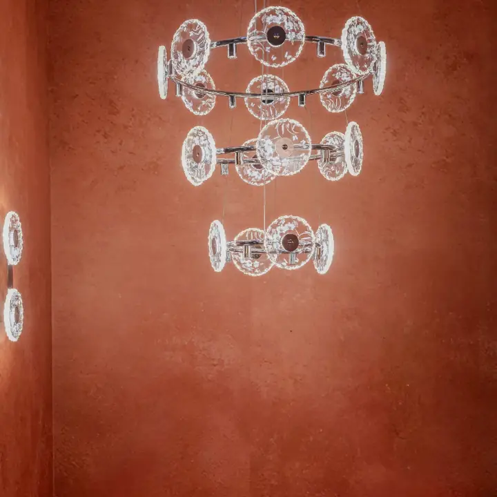 Aristo crystal wall lights mounted in a row on a terracotta wall