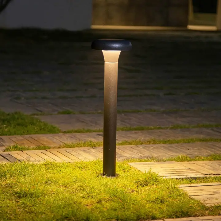 Leios bollard lighting a lawn beside a path