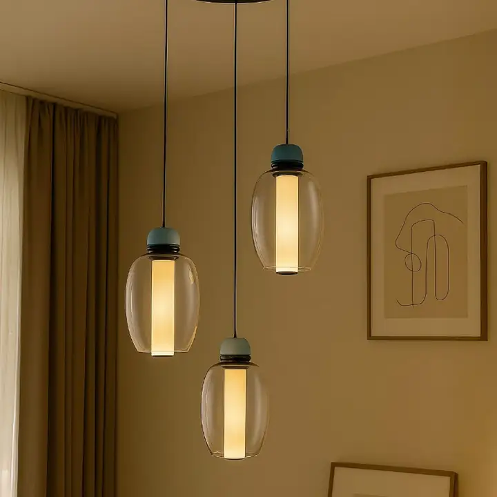 Riggo pendants with double-layer glass tubes over a dining space