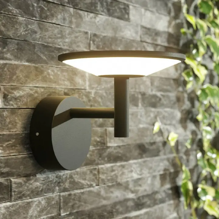 Scandia disc sconce on a stacked stone wall