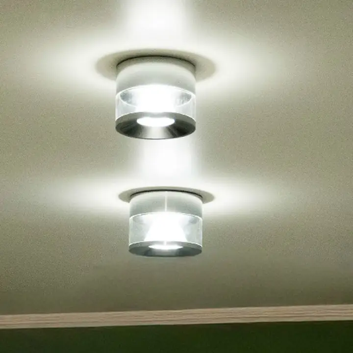 Stallo chrome surface downlights on a ceiling above a green wall