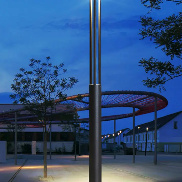Tower-P pole lights standing over a public plaza at dusk